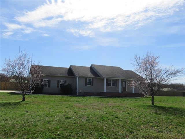 Front of home with covered front porch, fenced huge back yard, concrete driveway and tons of updates inside. 
