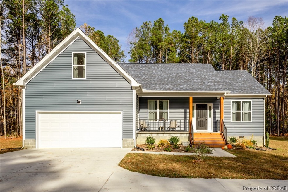 View of front of home with a porch and a garage