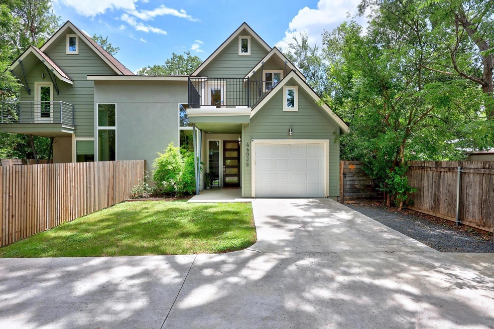 View of front of home featuring a balcony, drivew