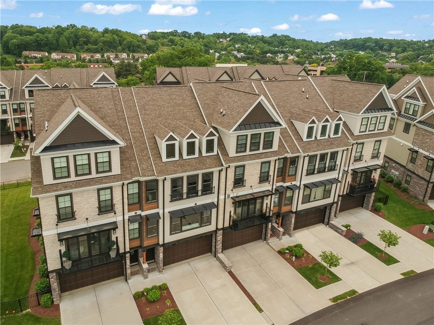 This upscale townhouse features stone and wood acc