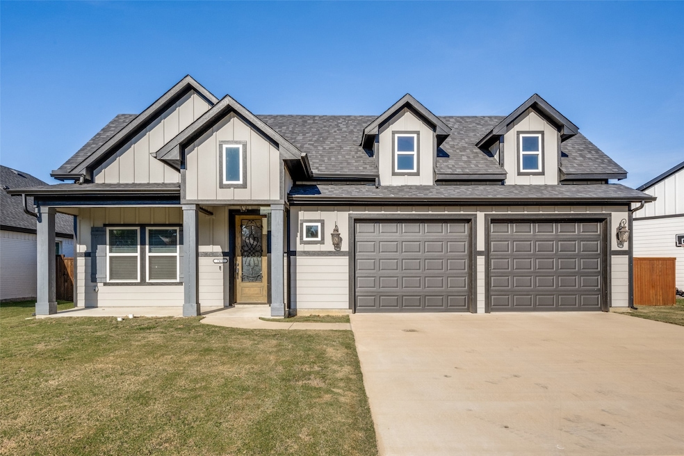 View of front of house featuring a shingled roof, a front lawn, board and batten siding, driveway, and covered porch