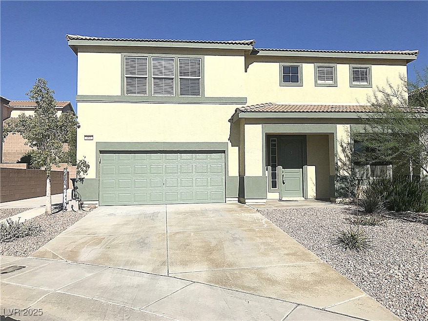 View of front of home with a tile roof, driveway, a garage, covered porch, and stucco siding