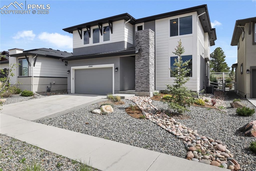 View of front facade with driveway and a garage