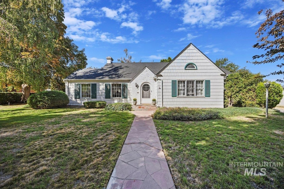 View of front of property with a front yard and a chimney