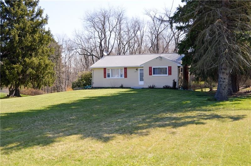 The home sits back of the road, the front yard is 