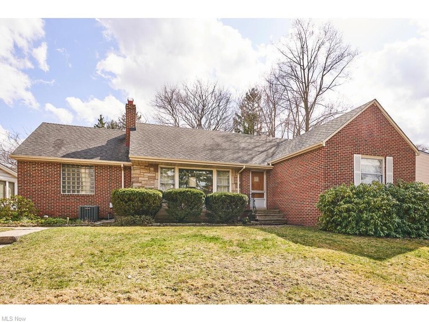 Solid brick ranch has a Mid Century Modern feel.