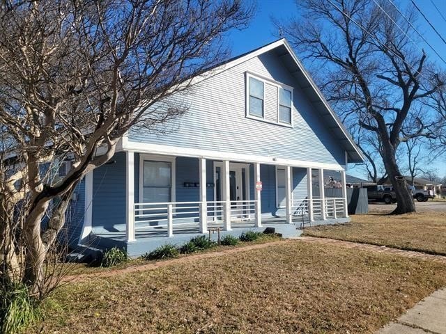 Bungalow-style house featuring a porch and a front yard