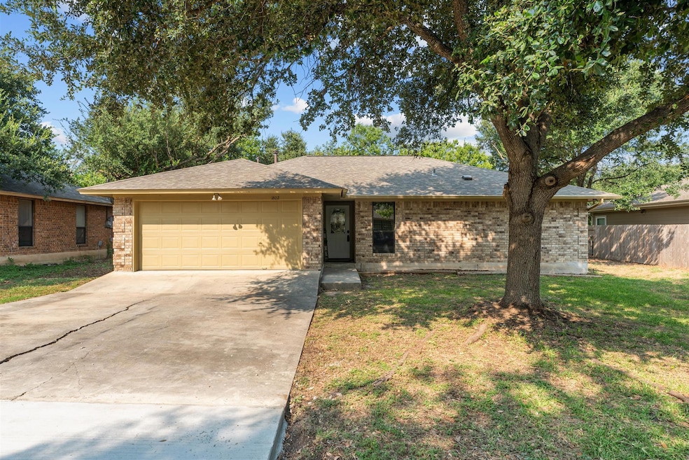 Ranch-style home with brick siding, a shingled roof, and a garage