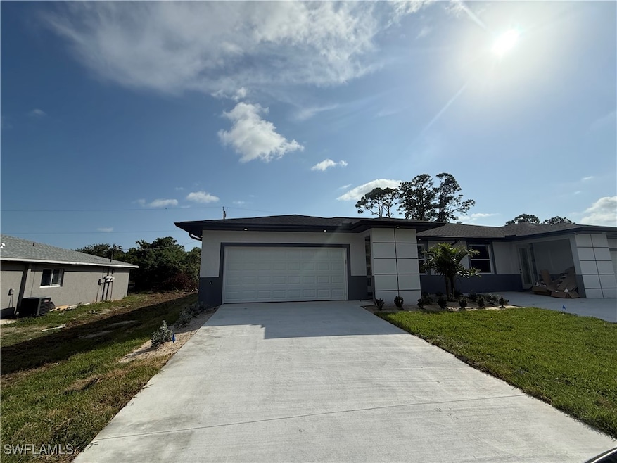 View of front of home with a garage, concrete driv