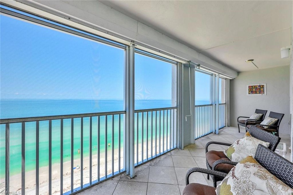 Sunroom featuring a water view