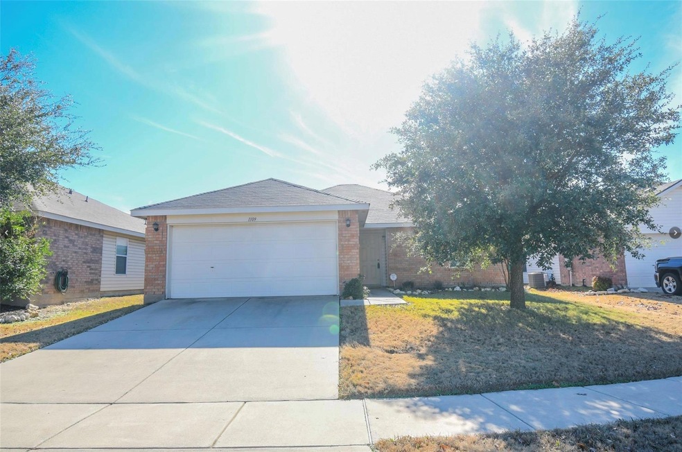 Ranch-style home with a garage and a front yard