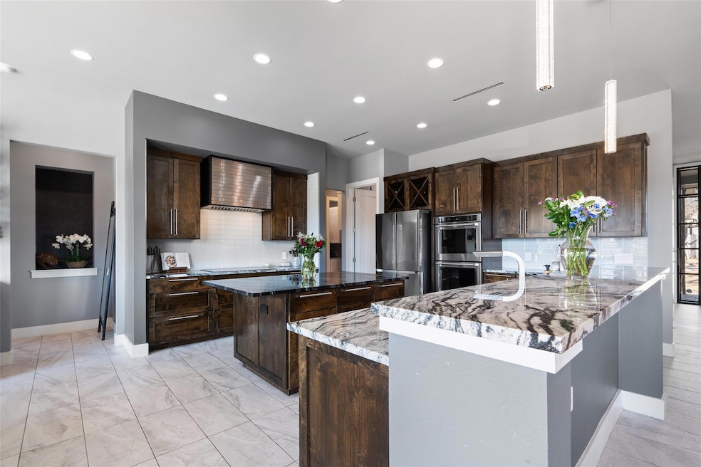 Kitchen featuring a center island, wall chimney r