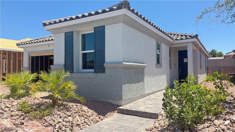 View of property exterior featuring a tile roof, s