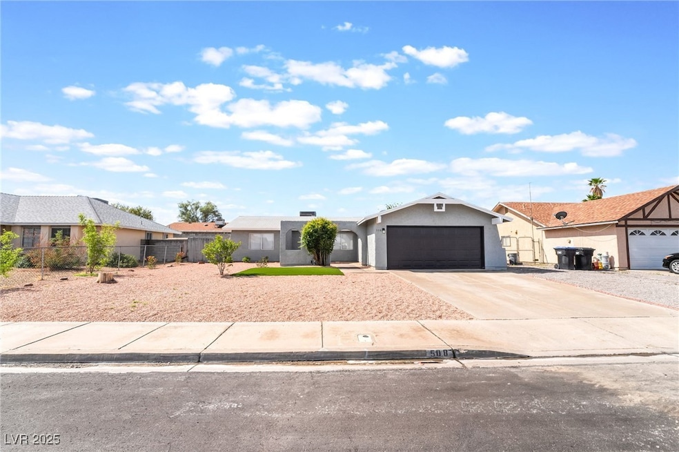 View of front of house with concrete driveway, fen