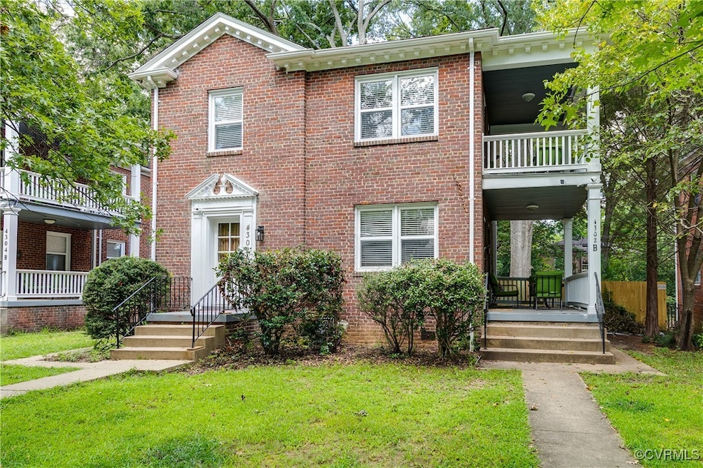 Colonial inspired home with a balcony, brick sidin