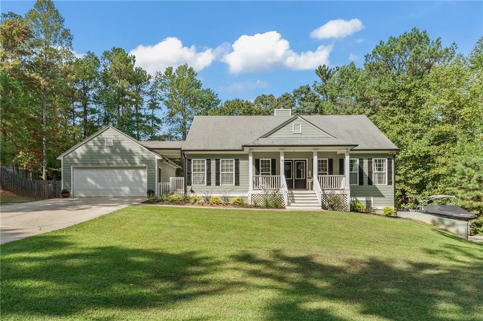 View of front of house featuring a front lawn, cov