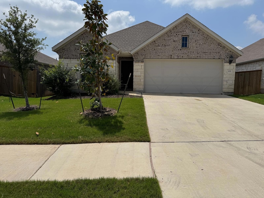 Single story home with fence, brick siding, a gar