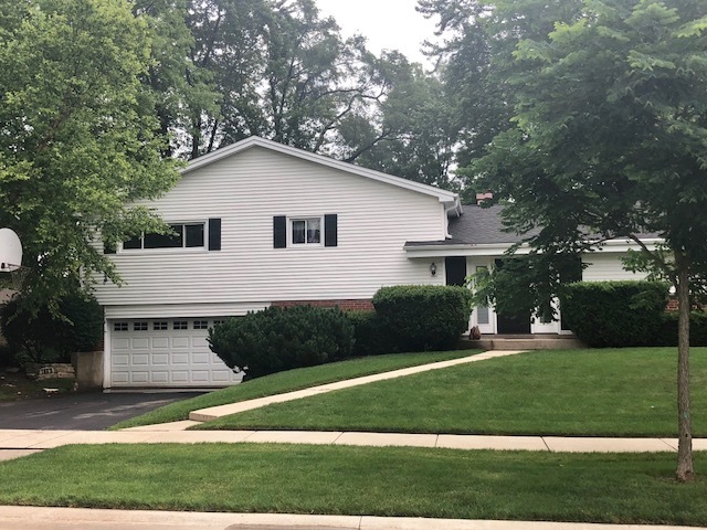 Home features newer siding, custom entry door, roo