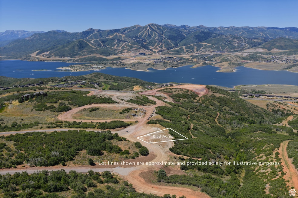 Aerial view of property's location featuring a water and mountain view