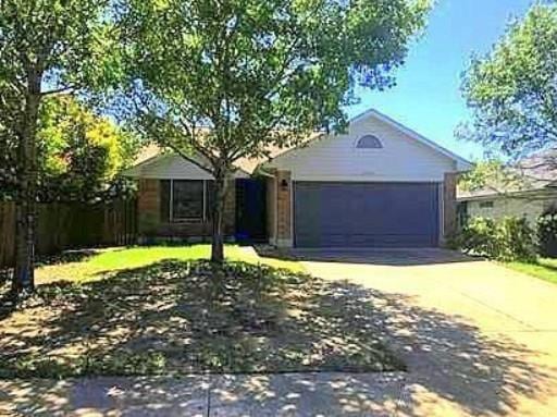 Single story home with concrete driveway and a ga