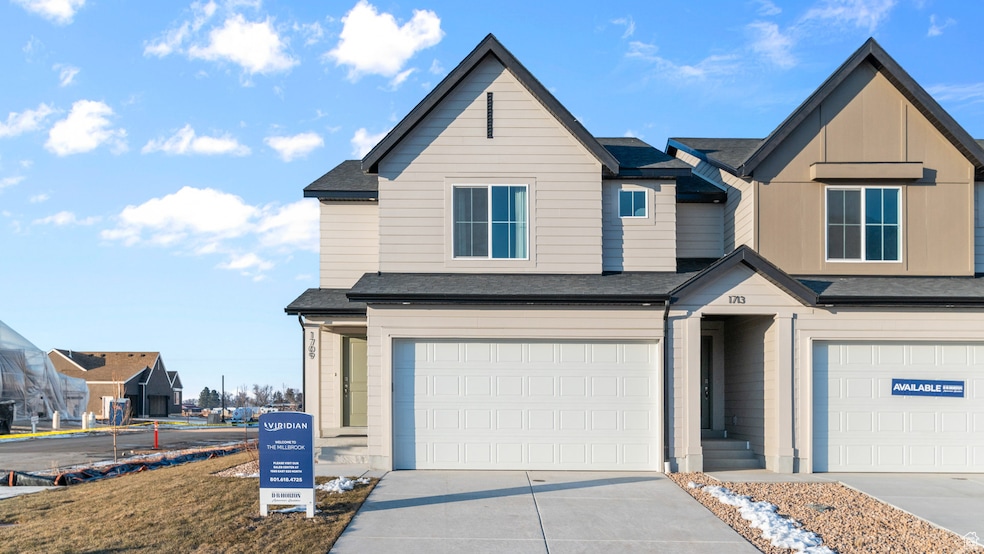 View of front of property with roof with shingles, driveway, a garage, and board and batten siding