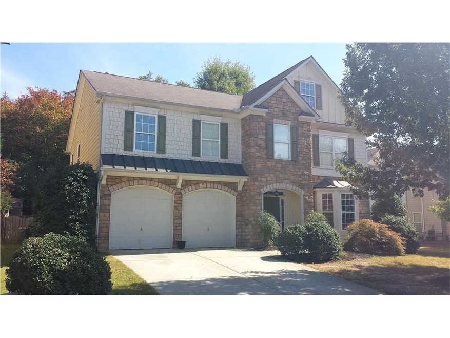 Front faade of home features stone and shakes as w