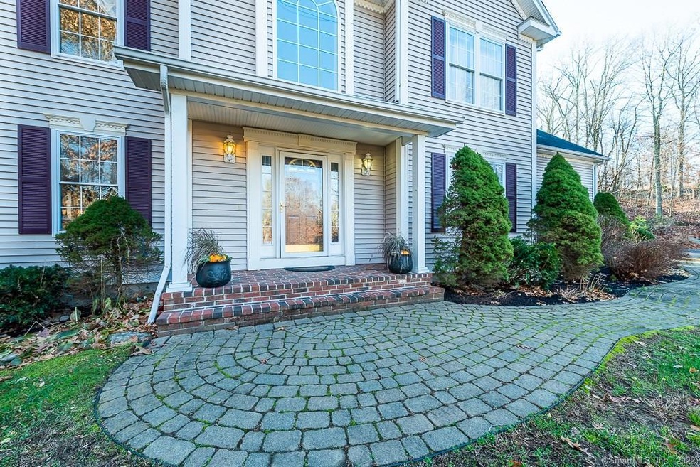 Lovely landscaped ample front walkway greets your 