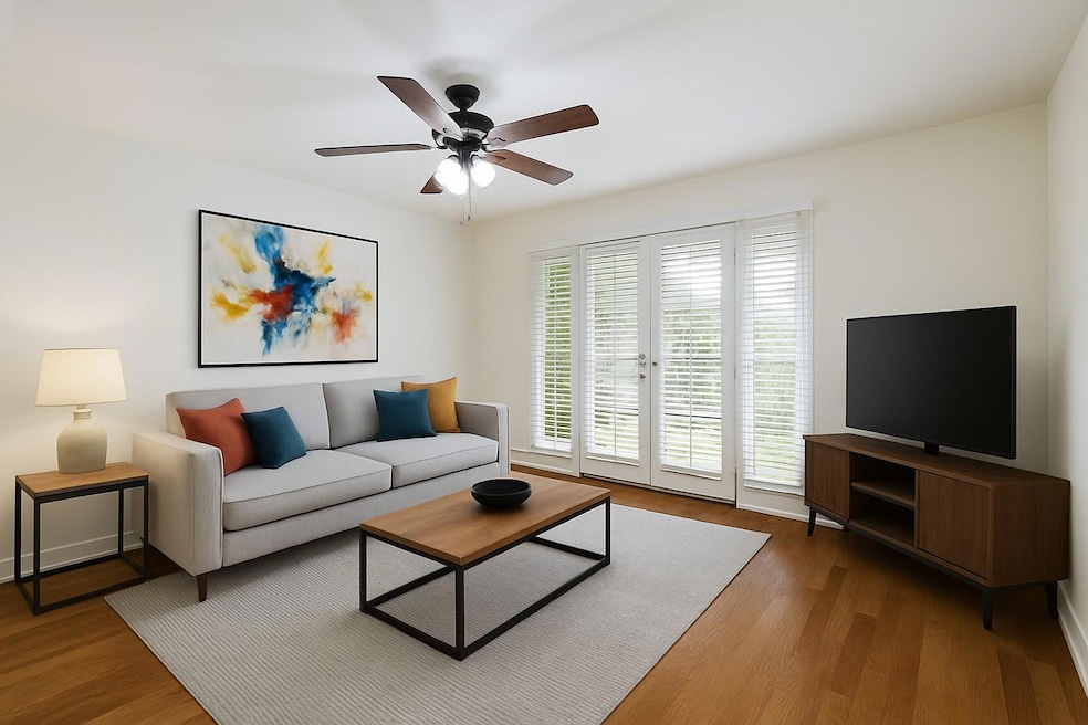 Living room with wood finished floors and a ceili