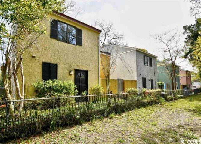 Back of property with fence and stucco siding