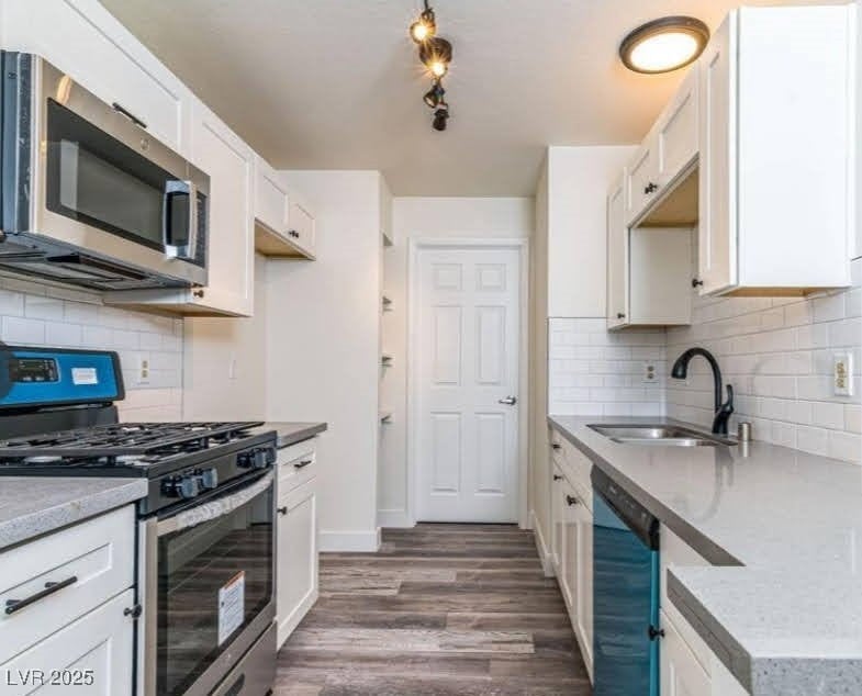 Kitchen featuring white cabinetry, dark wood-type