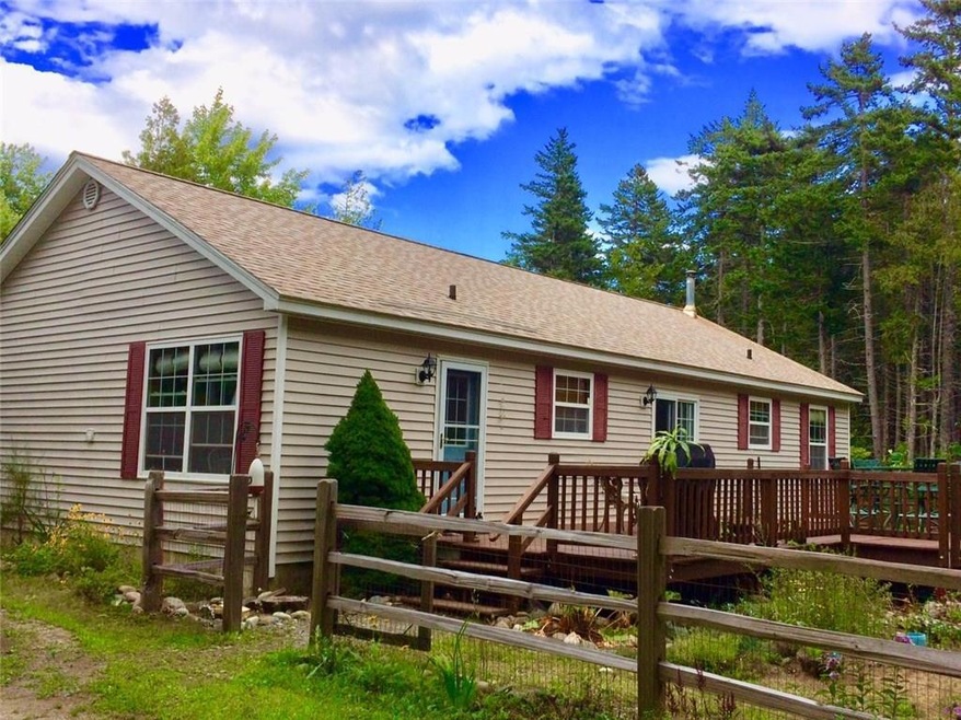 Exterior back of ranch home with...
