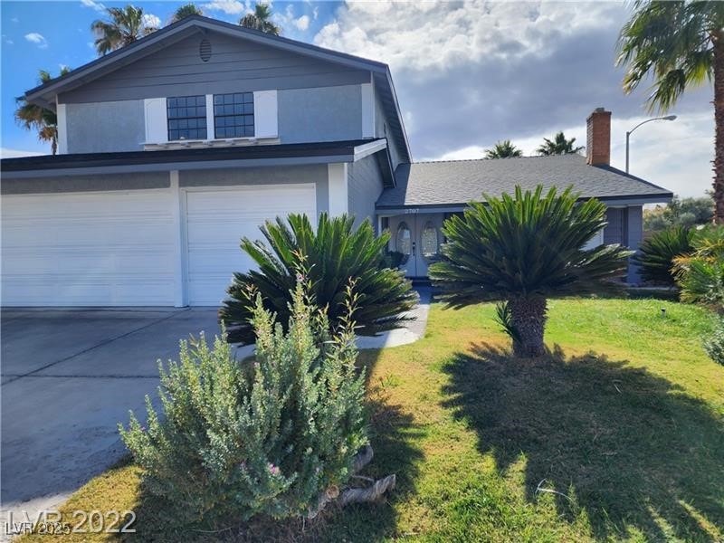 View of front of house with driveway, an attached