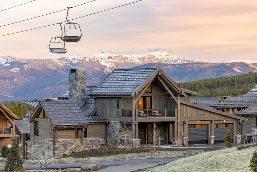 View of front of home with a mountain view, a balcony, and a​​‌​​​​‌​​‌‌​​​‌​‌​​​​​‌​​‌‌​​‌‌​​‌‌​​​​ garage