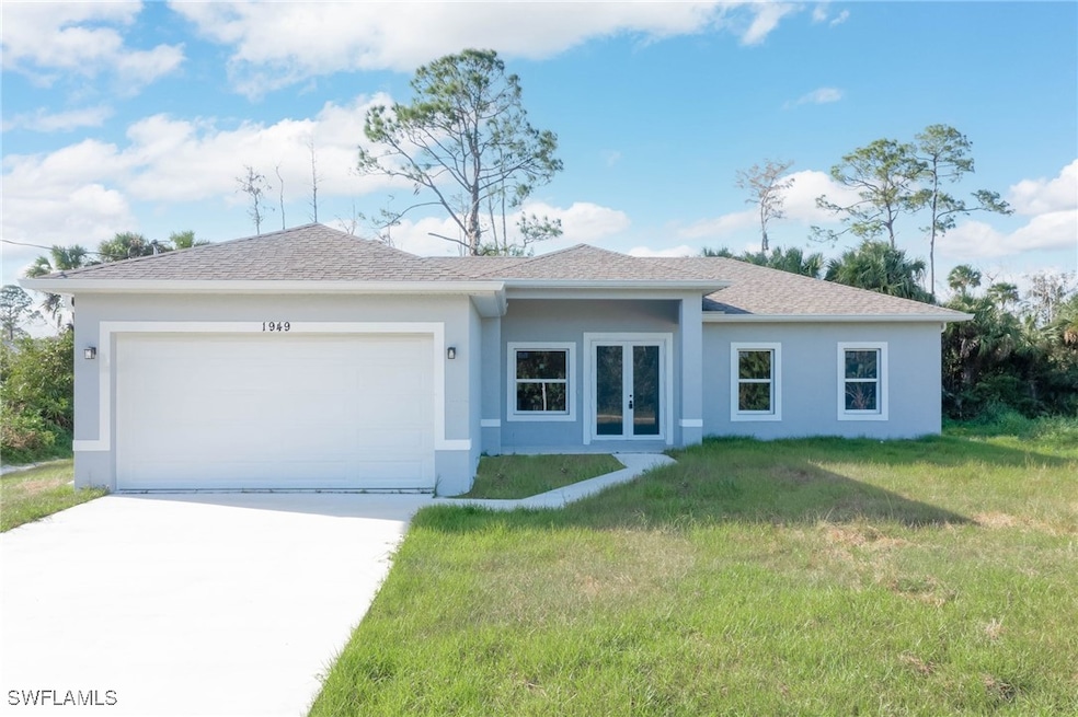 Single story home with a front lawn and a garage-
