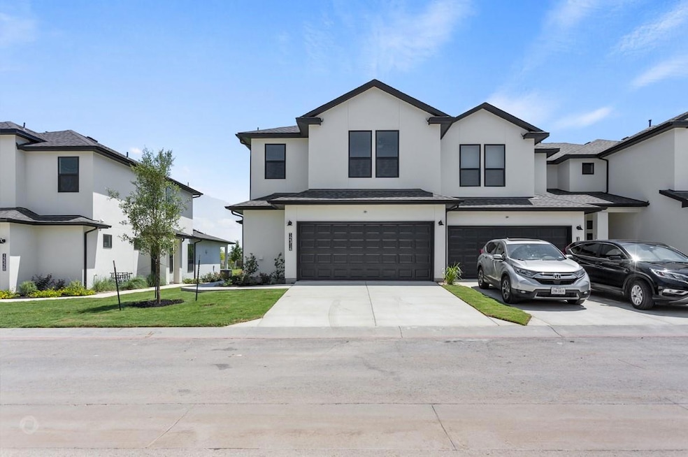 View of front of home with an attached garage, st