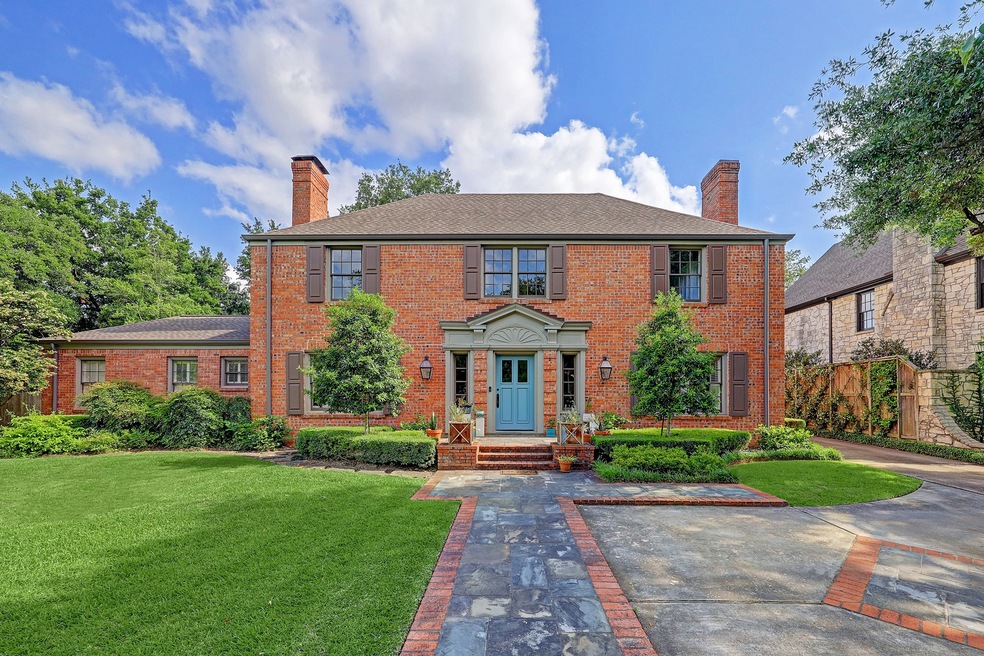 The clean cut landscaping helps to transform the exterior of this classic River Oaks home. The interiors are even more impressive.