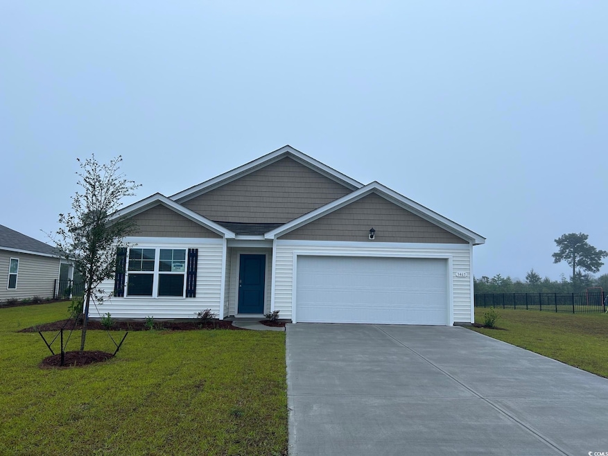 Ranch-style home featuring concrete driveway and an attached garage