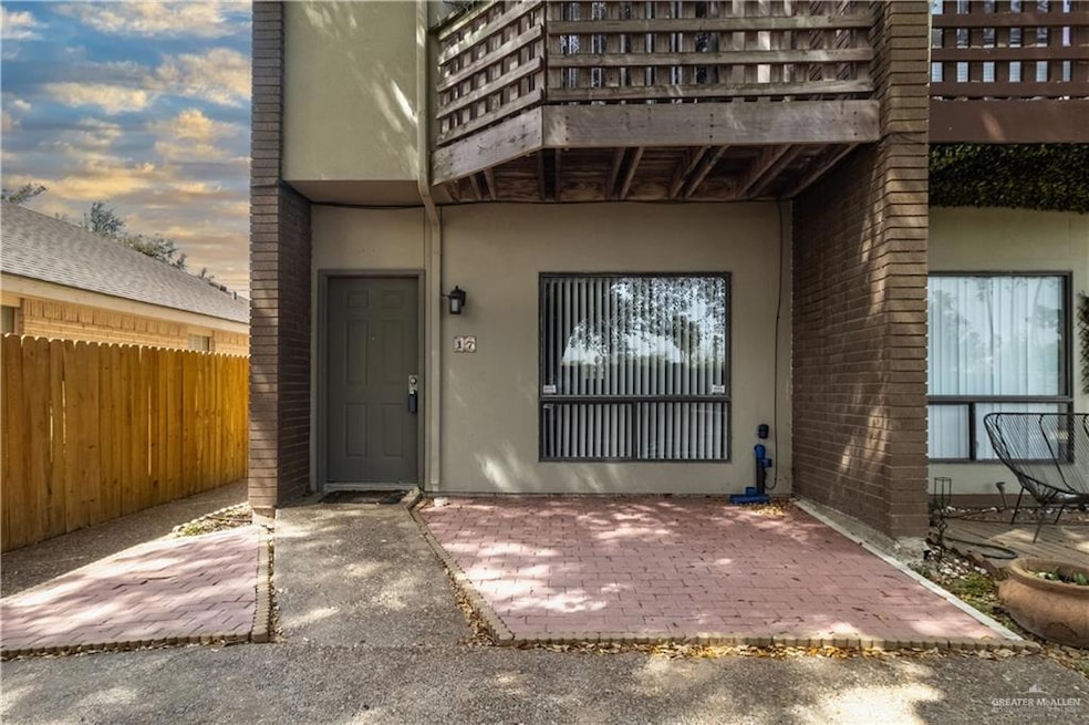 Entrance to property featuring covered front patio facing the picnic area and mature tree.
