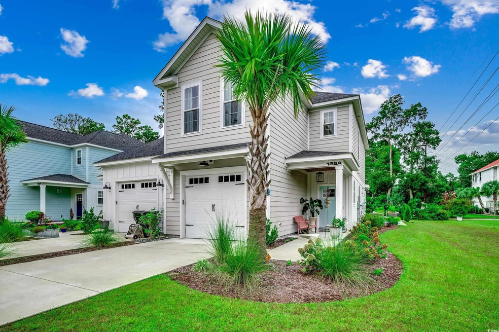 Front facade with a garage and a front lawn