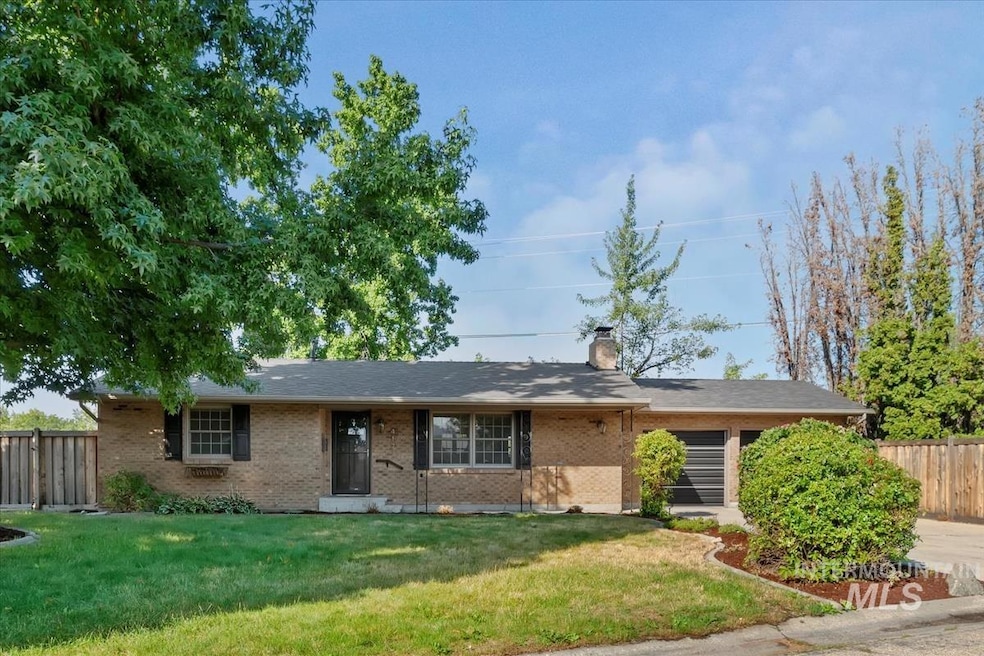 Single story home featuring brick siding and a chimney