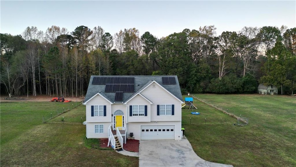 Split foyer home with solar panels, a front lawn, 