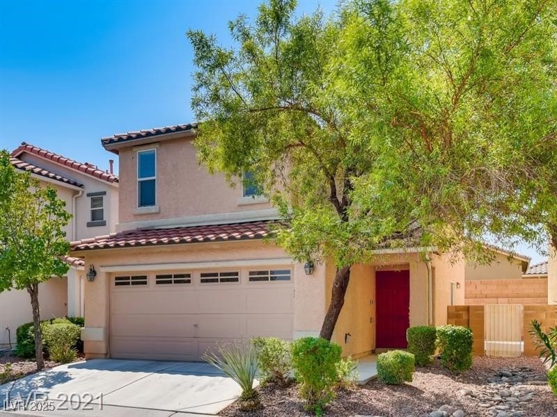 View of front of home featuring a garage, stucco s