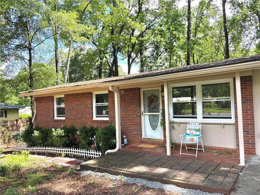 Single story home with brick siding and fence