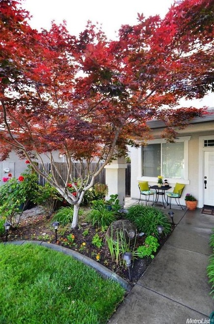 Abundant and fresh landscaping surrounds this home