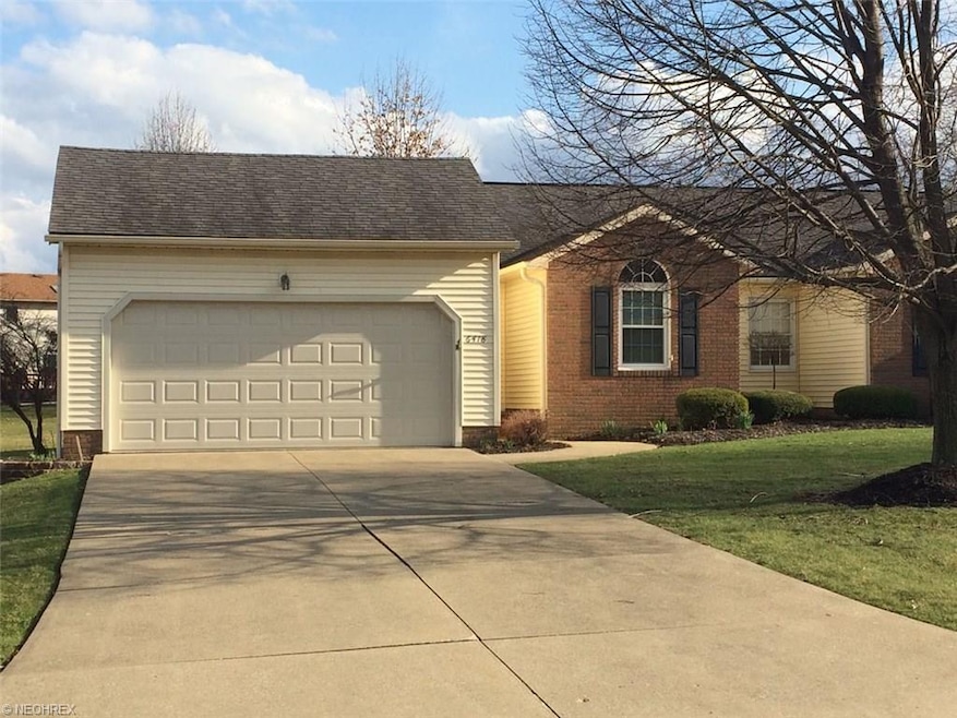 Front of ranch-style condo with 2-car garage, part