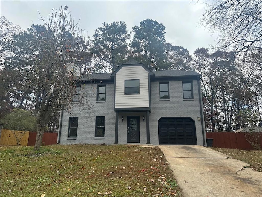 Front of property with a garage and a front yard