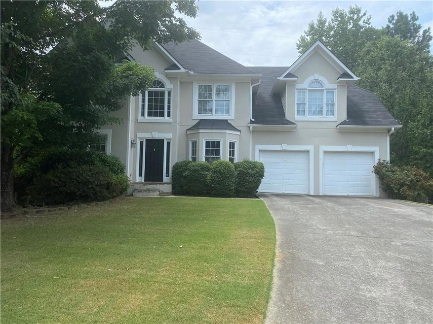 View of front of property featuring a garage and a
