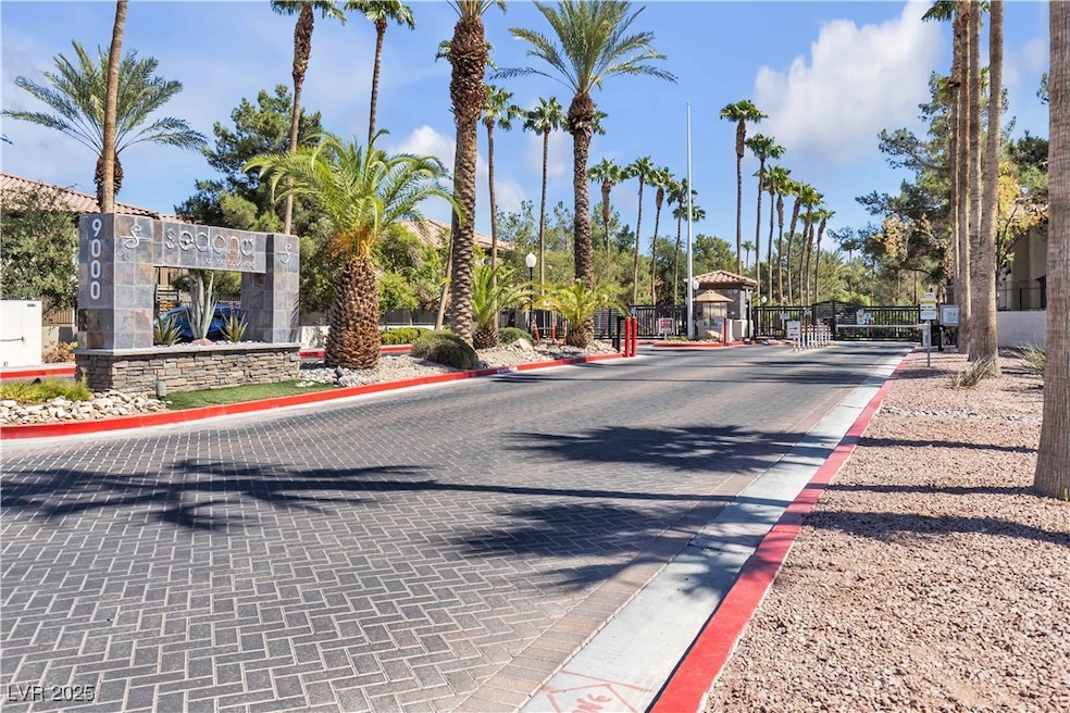 View of street featuring curbs, a gated entry, and