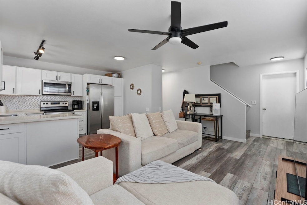 Open kitchen with lots of kitchen storage. Door to