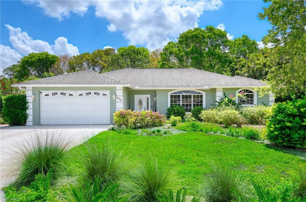 Ranch-style house featuring an attached garage, driveway, stucco siding, and a front yard